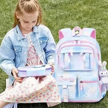 Kids light blue backpack with pink trim, open front compartments and plush bunny keychain