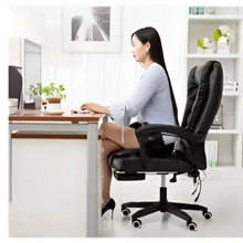 Dark leather ergonomic office chair with armrests and footrest, swivel base