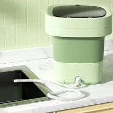 Portable 8L laundry washer on counter with drain hose and control