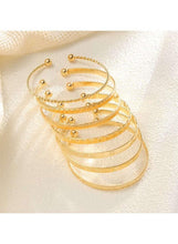 Gold tone cuff bangles with layered openwork and tiny dot embellishments