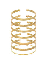 Gold tone bangle bracelet set with textured bands and small round bead accents