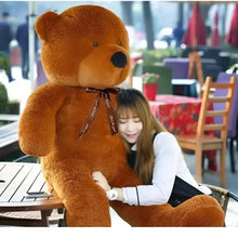 Large brown teddy bear plush with black bow ribbon and stitched paw details