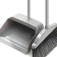 Dustpan and long-handled broom set with gray pan and black bristles, close-up.