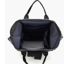 Black diaper backpack open with wide interior storage compartments