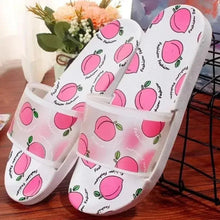 White peach-print slide sandals with wide strap over the foot