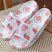 Peach-print slide sandals with white sole and pink fruit motif straps