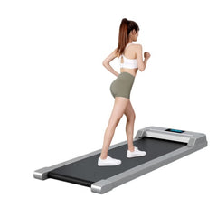 Huitich portable walking treadmill with sleek design and digital display being used by woman exercising
