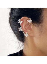 Crystal butterfly ear cuff earrings with curved silver band, side view on model