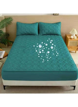 Waterproof mattress protector, teal green quilted top with water droplet pattern
