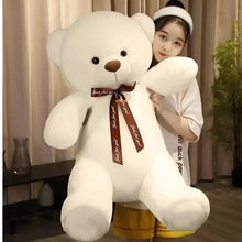 White teddy bear plush with brown ribbon bow, seated pose