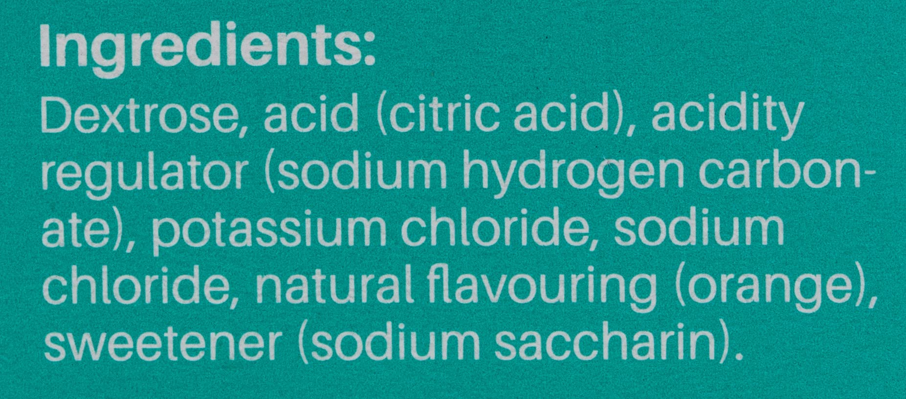 Close up ingredients label listing dextrose citric acid potassium and sodium chloride for electrolyte effervescent tablets orange