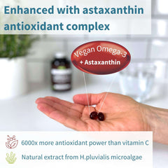 Igennus hand holding two dark softgel capsules with astaxanthin vegan omega 3 supplement UAE