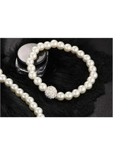 Faux pearl necklace and bracelet set with sparkling charm detail