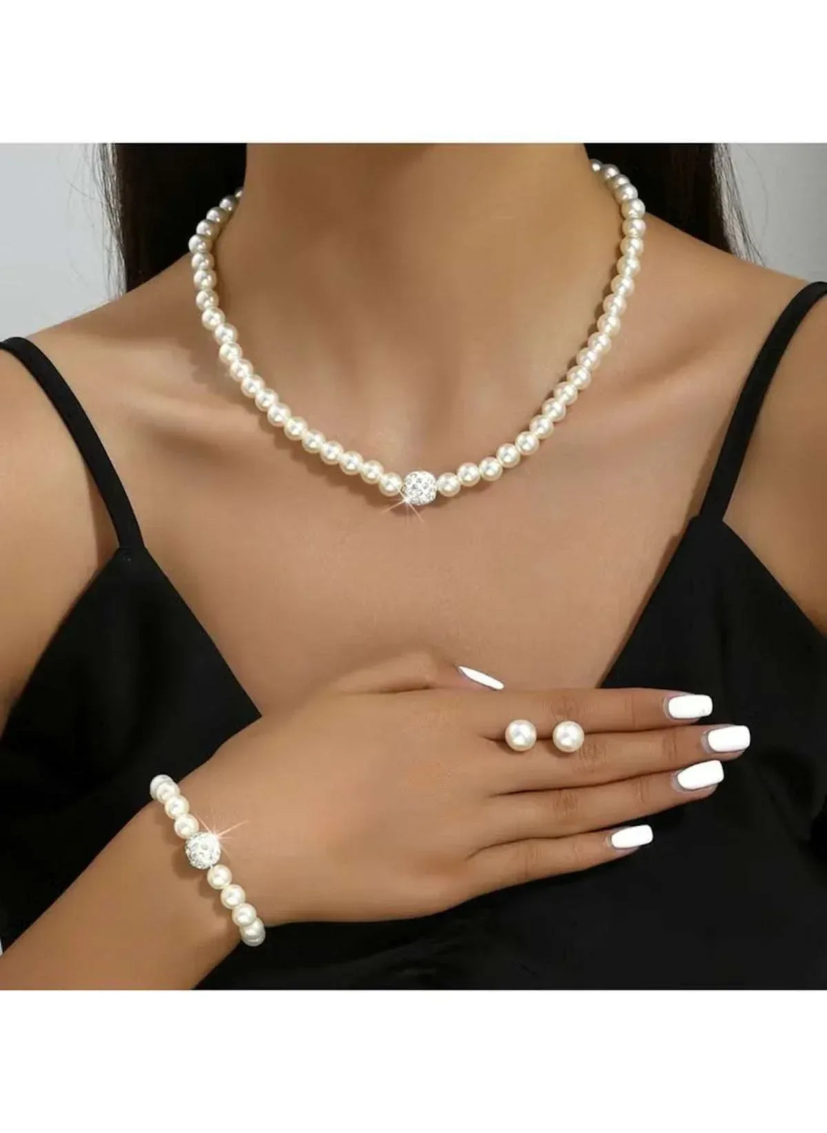 Faux pearl necklace and bracelet worn together with pearl button charm