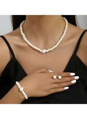 Faux pearl necklace and bracelet worn together with pearl button charm