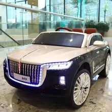 Kids electric ride-on car: dark front with chrome grille, blue LED lights, front-left view