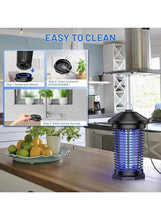 Mosquito killer lamp with black protective cage and blue UV grid on countertop