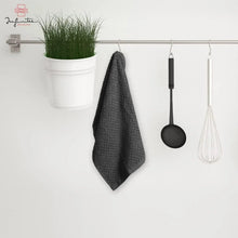 Dark gray striped cotton kitchen towel hanging from hooks