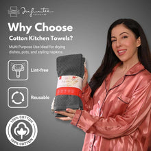 Folded dark gray cotton kitchen towel held in a person’s hand