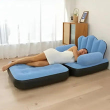 Blue inflatable lounge chair bed with armrests, shown in use for reclining