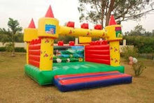 Inflatable bouncing house castle with red sidewalls, green base, and yellow towers