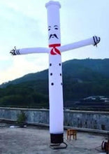Inflatable chef tube outdoors, white suit with black dots and red bow tie, raised arms