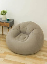 Inflatable lounge chair in light taupe, bean-shaped seat with raised arm support