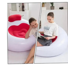 Inflatable lounge chair with white base and red heart-shaped seat, resting backrest