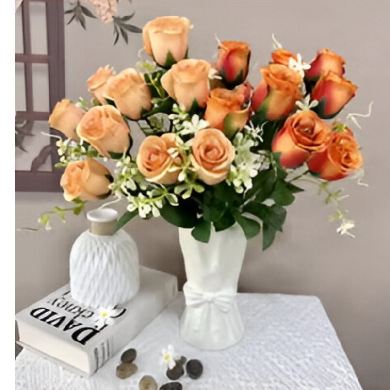 Huitich artificial flowers bouquet in white vase beside book and decor featuring an inflatable lounge chair with backrest keyword