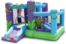 Inflatable kids playhouse with slide, purple and blue walls, green floor and colorful accents