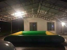 Inflatable outdoor swimming pool with green panels and yellow corner guards