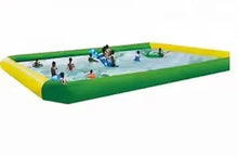 Inflatable outdoor swimming pool with yellow rim and green walls, filled with water