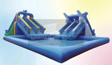 Inflatable blue swimming pool with slide towers and padded splash area
