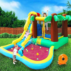 Colorful inflatable water slide for kids with palm tree design and attached splash pool in a backyard