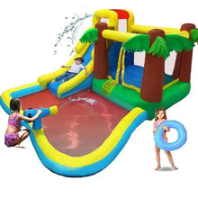 Kids inflatable water slide with water spray over red landing pad and palm tree canopy