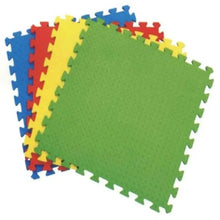 Interlocking foam floor mat tiles in green with blue, red, and yellow corner pieces