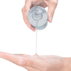 FDTY clear gel lubricant being poured from bottle onto palm showing texture and smooth flow water based lube UAE