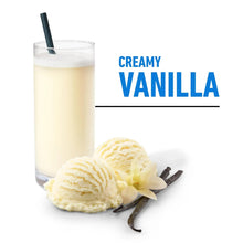 Creamy vanilla protein shake in a glass with vanilla pods and a scoop