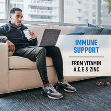 Protein powder tub held by seated man on couch with immune support callout