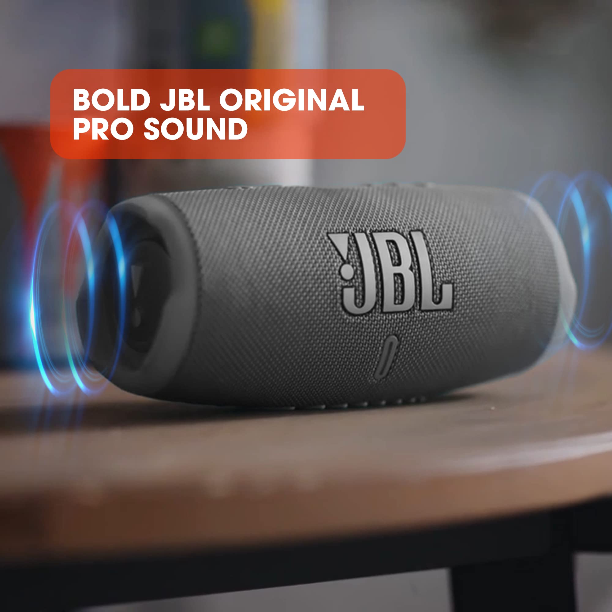 JBL Charge 5 portable Bluetooth speaker in black on wooden surface with sound waves graphic