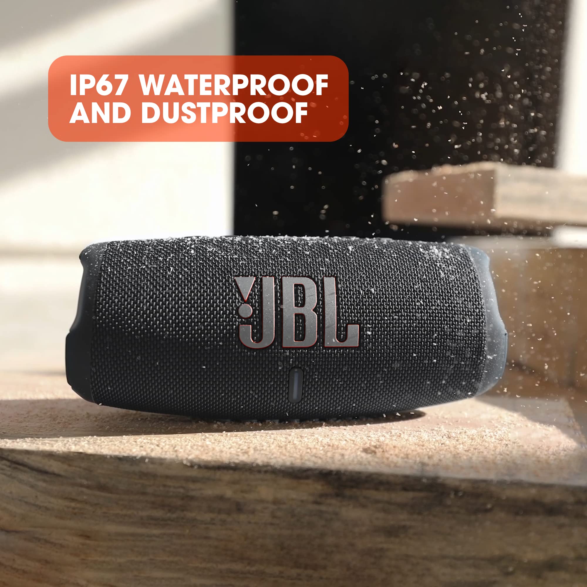 JBL Charge 5 portable Bluetooth speaker with IP67 waterproof and dustproof design on a wooden surface
