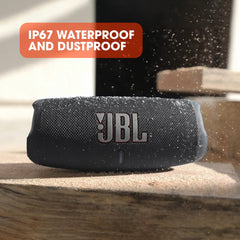 JBL Charge 5 portable Bluetooth speaker with IP67 waterproof and dustproof design on a wooden surface