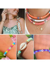 Beaded necklace and bracelets with metal charms on a model