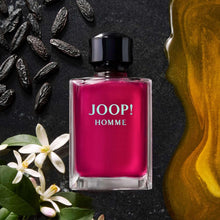 Joop Homme men’s perfume bottle with pink liquid and dark plum cap, front view.