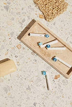 Whitening brush heads with blue bristles on short white handles