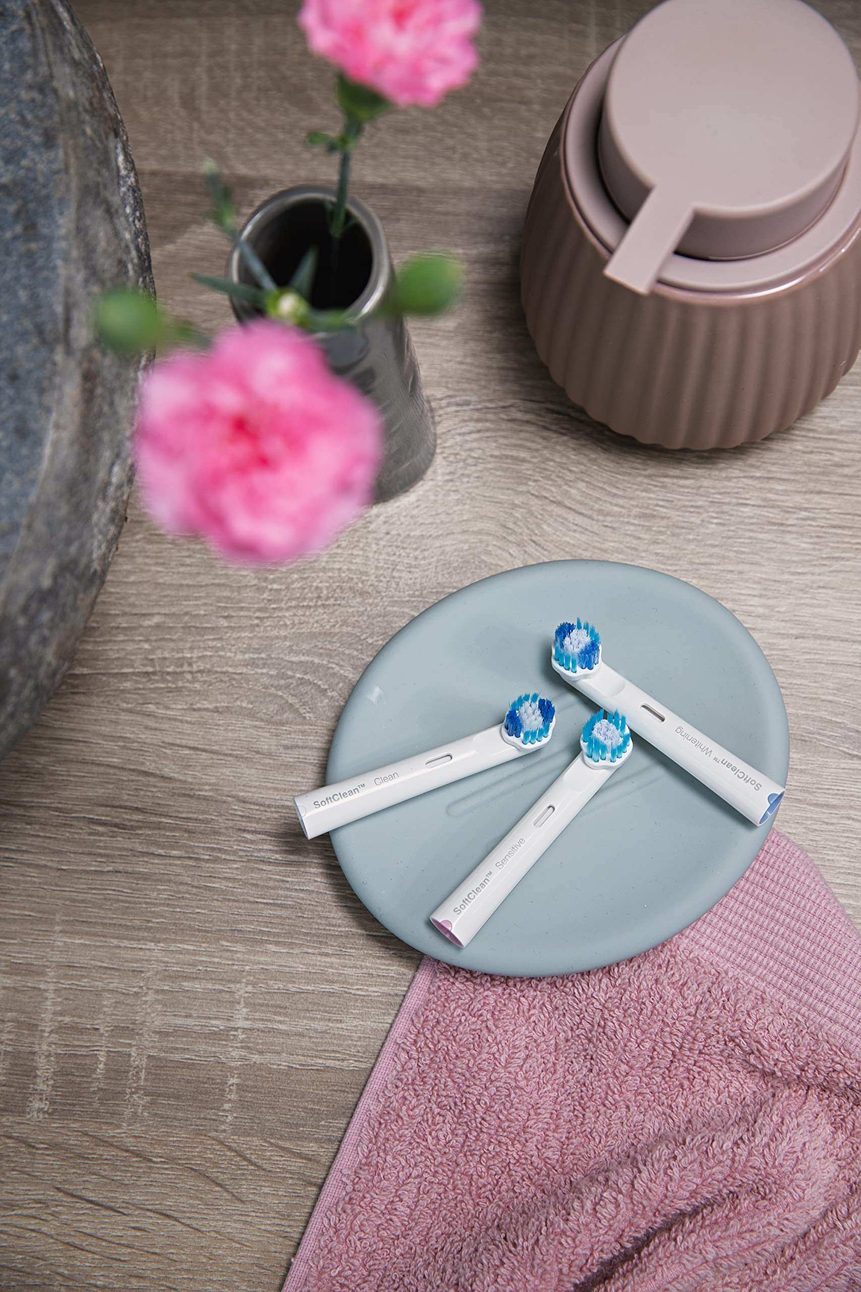 Jordan whitening electric toothbrush replacement head pack of three with blue bristles on bathroom plate