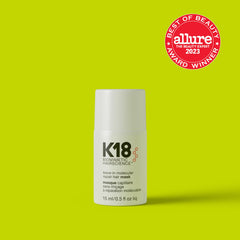 K18 leave-in molecular repair hair mask bottle with white packaging on green background