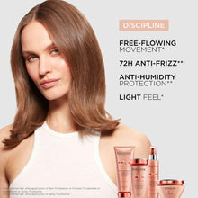 Pink shampoo bottle, spray, and jar with red caps near a model