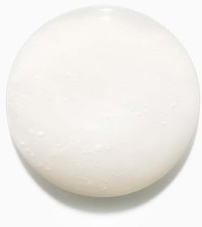 Kérastase Discipline sulfate-free shampoo shown as a creamy white texture suitable for smooth hair care