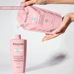 Kerastase Chroma Absolu Moisturizing Shampoo for color-treated hair in a pink bottle pouring into a hand